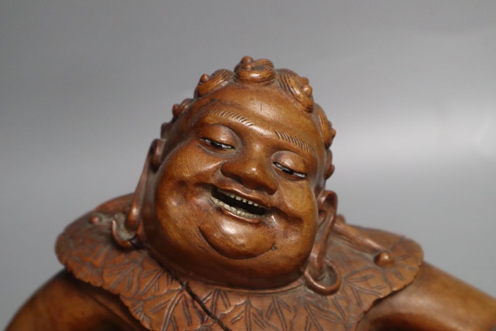 A Chinese hardwood group of Liu Hai and his three legged toad, early 20th century, together with an ebonised wood stand, length 36cm